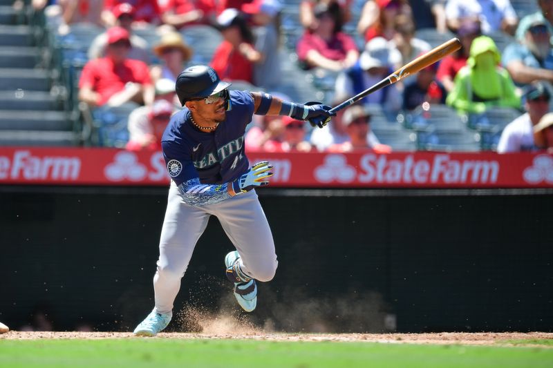 Jul 14, 2024; Anaheim, California, USA; Seattle Mariners center fielder Julio Rodriguez (44) hits a single against the Los Angeles Angels during the sixth inning at Angel Stadium. Mandatory Credit: Gary A. Vasquez-USA TODAY Sports