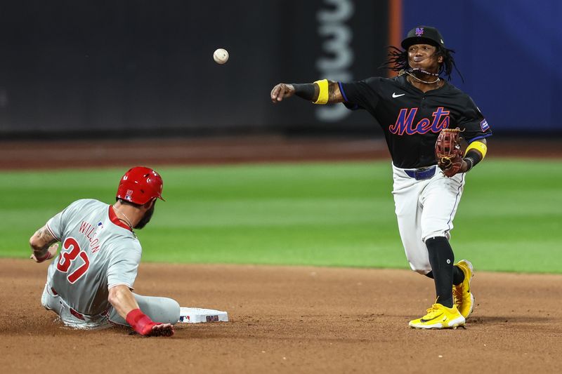 Sep 19, 2024; New York City, New York, USA;  New York Mets shortstop Luisangel Acuña (2) throws past Philadelphia Phillies outfielder Weston Wilson (37) attempting to complete a double play in the seventh inning at Citi Field. Mandatory Credit: Wendell Cruz-Imagn Images