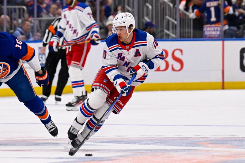 Feb 25, 2025; Elmont, New York, USA;  New York Rangers left wing Artemi Panarin (10) skates across center ice against the New York Islanders during the first period at UBS Arena. Mandatory Credit: Dennis Schneidler-Imagn Images