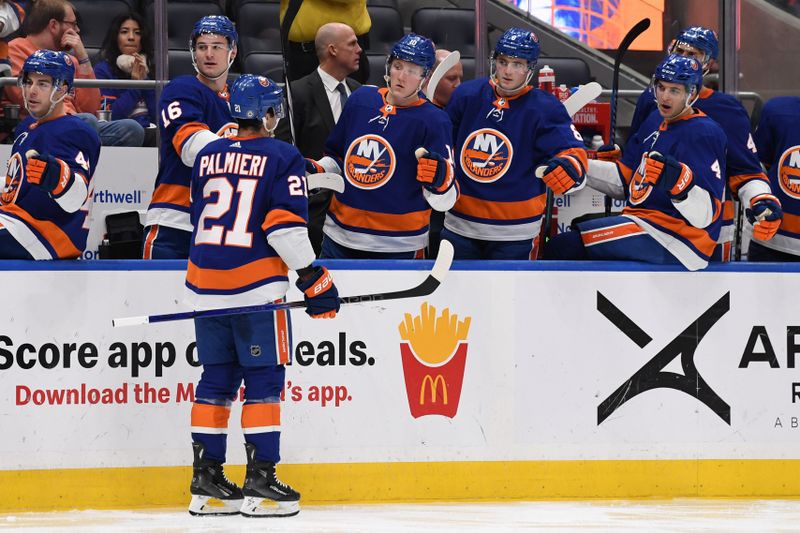 Dec 13, 2023; Elmont, New York, USA; New York Islanders center Kyle Palmieri (21) celebrates his goal against the Anaheim Ducks with the New York Islanders bench during the second period at UBS Arena. Mandatory Credit: Dennis Schneidler-USA TODAY Sports