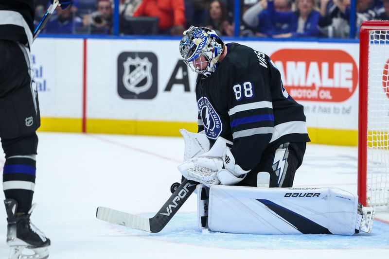 Nov 16, 2024; Tampa, Florida, USA; Tampa Bay Lightning goaltender Andrei Vasilevskiy (88) makes a save against the New Jersey Devils in the second period at Amalie Arena. Mandatory Credit: Nathan Ray Seebeck-Imagn Images