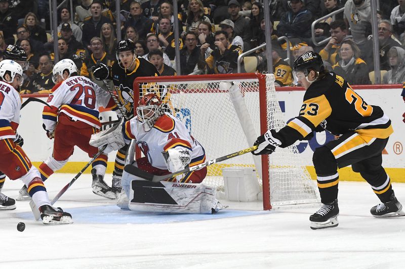 Dec 30, 2022; Pittsburgh, Pennsylvania, USA; Pittsburgh Penguins left wing Brock McGinn (23) moves the puck in front of New Jersey Devils goalie Vitek Vanecek (41) during the third period at PPG Paints Arena. Mandatory Credit: Philip G. Pavely-USA TODAY Sports