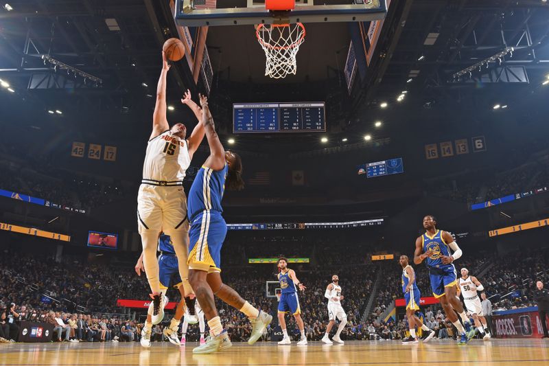 SAN FRANCISCO, CA - JANUARY 4: Nikola Jokic #15 of the Denver Nuggets drives to the basket during the game against the Golden State Warriors on January 4, 2024 at Chase Center in San Francisco, California. NOTE TO USER: User expressly acknowledges and agrees that, by downloading and or using this photograph, user is consenting to the terms and conditions of Getty Images License Agreement. Mandatory Copyright Notice: Copyright 2024 NBAE (Photo by Noah Graham/NBAE via Getty Images)