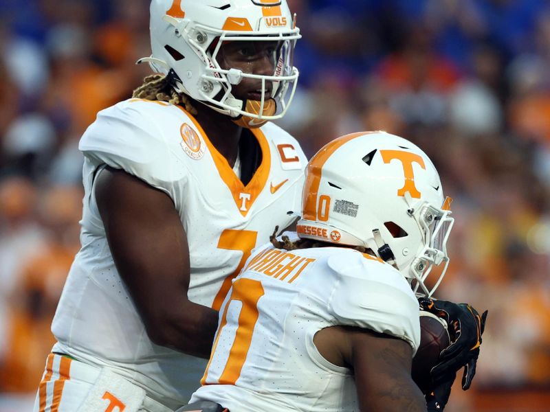 Sep 16, 2023; Gainesville, Florida, USA;Tennessee Volunteers quarterback Joe Milton III (7) hands the ball off to running back Jaylen Wright (0) against the Florida Gators  during the first quarter at Ben Hill Griffin Stadium. Mandatory Credit: Kim Klement Neitzel-USA TODAY Sports