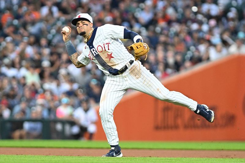 Jul 22, 2023; Detroit, Michigan, USA; Detroit Tigers shortstop Javier Baez (28) tries to throw out San Diego Padres designated hitter Xander Bogaerts (2) on a ground ball in the fifth inning at Comerica Park. Bogaerts beat the throw for an infield single. Mandatory Credit: Lon Horwedel-USA TODAY Sports