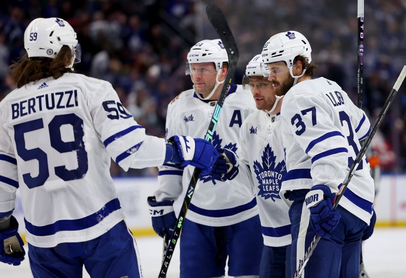 Dec 21, 2023; Buffalo, New York, USA;  Toronto Maple Leafs center Max Domi (11) celebrates his goal with teammates during the first period against the Buffalo Sabres at KeyBank Center. Mandatory Credit: Timothy T. Ludwig-USA TODAY Sports