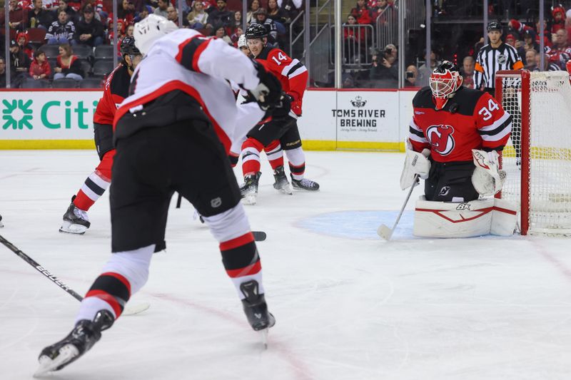 Mar 22, 2025; Newark, New Jersey, USA; New Jersey Devils goaltender Jake Allen (34) makes a save on Ottawa Senators left wing Brady Tkachuk (7) during the first period at Prudential Center. Mandatory Credit: Ed Mulholland-Imagn Images