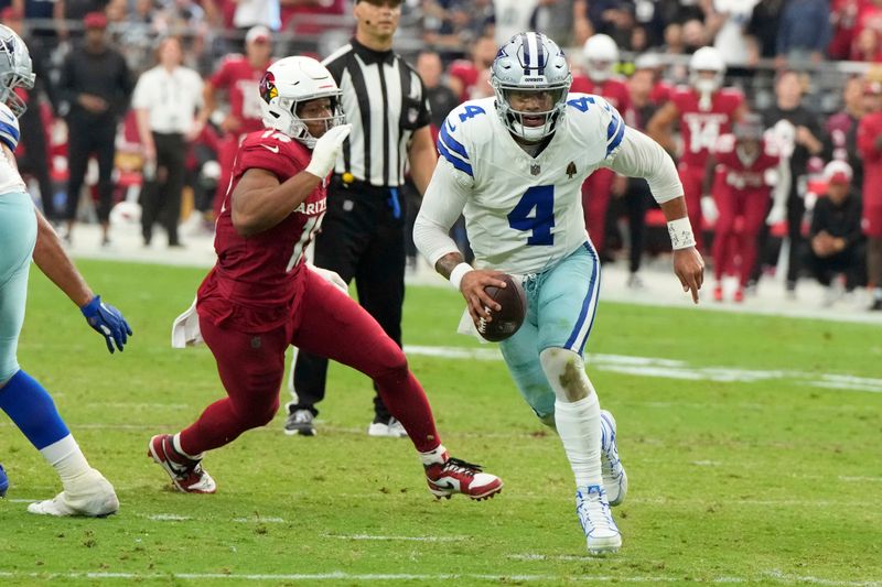 Dallas Cowboys quarterback Dak Prescott (4) runs the ball against the Arizona Cardinals during the first half of an NFL football game, Sunday, Sept. 24, 2023, in Glendale, Ariz. (AP Photo/Rick Scuteri)