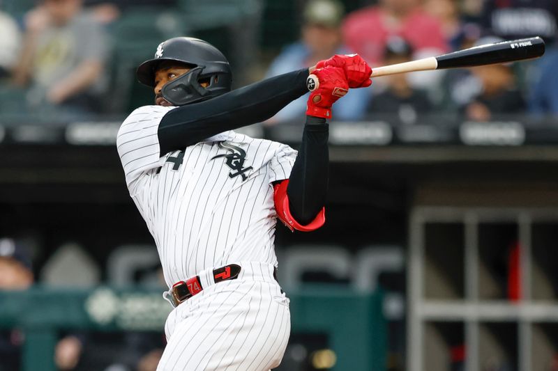 Sep 16, 2023; Chicago, Illinois, USA; Chicago White Sox designated hitter Eloy Jimenez (74) hits a two-run home run against the Minnesota Twins during the first inning at Guaranteed Rate Field. Mandatory Credit: Kamil Krzaczynski-USA TODAY Sports