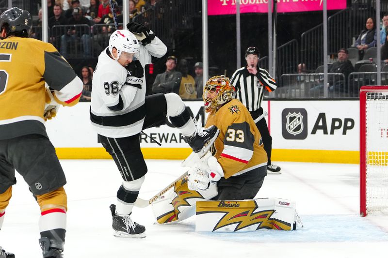 Feb 5, 2026; Las Vegas, Nevada, USA; Los Angeles Kings left wing Andrei Kuzmenko (96) reacts after being struck in the head by the puck in front of Vegas Golden Knights goaltender Adin Hill (33) during the first period at T-Mobile Arena. Mandatory Credit: Stephen R. Sylvanie-Imagn Images