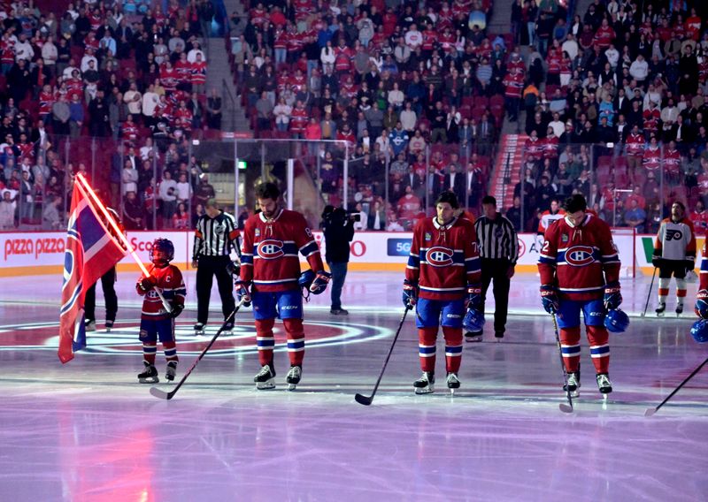 Sep 23, 2024; Montreal, Quebec, CAN; Montreal Canadiens and Philadelphia players during the 13 seconds of silence in honor of the Gaudreau brothers before their game at the Bell Centre. Mandatory Credit: Eric Bolte-Imagn Images