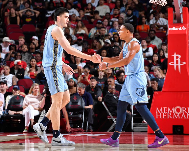 HOUSTON, TX - OCTOBER 25: Zach Edey #14 and Desmond Bane #22 of the Memphis Grizzlies high five during the game against the Memphis Grizzlies on October 25, 2024 at the Toyota Center in Houston, Texas. NOTE TO USER: User expressly acknowledges and agrees that, by downloading and or using this photograph, User is consenting to the terms and conditions of the Getty Images License Agreement. Mandatory Copyright Notice: Copyright 2024 NBAE (Photo by Logan Riely/NBAE via Getty Images)