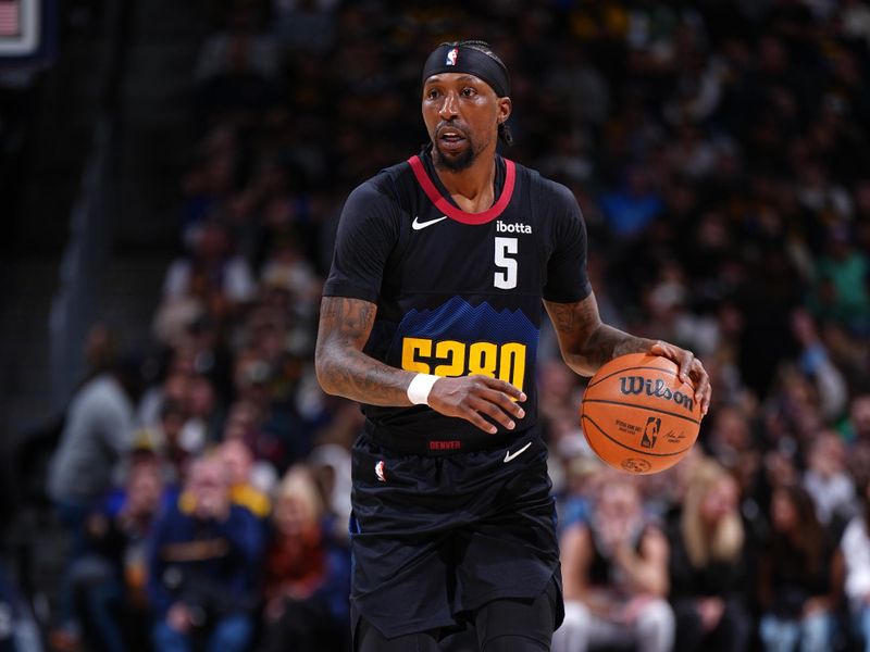 DENVER, CO - JANUARY 7: Kentavious Caldwell-Pope #5 of the Denver Nuggets brings the ball up court against the Detroit Pistons on January 7, 2024 at the Ball Arena in Denver, Colorado. NOTE TO USER: User expressly acknowledges and agrees that, by downloading and/or using this Photograph, user is consenting to the terms and conditions of the Getty Images License Agreement. Mandatory Copyright Notice: Copyright 2024 NBAE (Photo by Garrett Ellwood/NBAE via Getty Images)