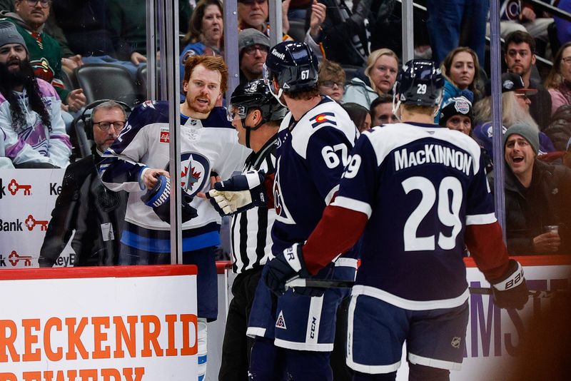Jan 22, 2025; Denver, Colorado, USA; Winnipeg Jets center Mason Appleton (22) and Colorado Avalanche defenseman Keaton Middleton (67) exchange words as center Nathan MacKinnon (29) looks on in the second period at Ball Arena. Mandatory Credit: Isaiah J. Downing-Imagn Images