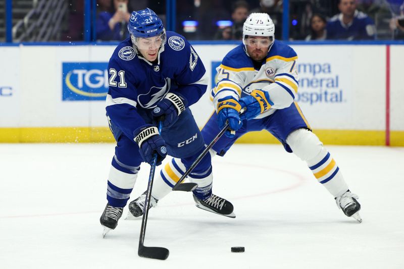 Feb 29, 2024; Tampa, Florida, USA;  Tampa Bay Lightning center Brayden Point (21) controls the puck from Buffalo Sabres defenseman Connor Clifton (75) in the first period at Amalie Arena. Mandatory Credit: Nathan Ray Seebeck-USA TODAY Sports