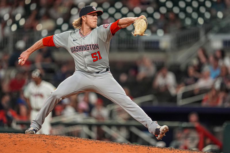May 29, 2024; Cumberland, Georgia, USA; Washington Nationals relief pitcher Jordan Weems (51) pitches against the Atlanta Braves during the ninth inning at Truist Park. Mandatory Credit: Dale Zanine-USA TODAY Sports