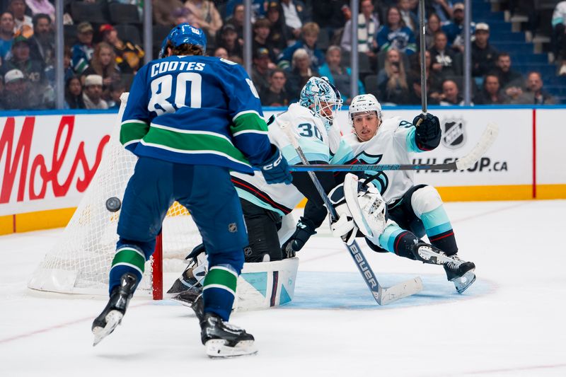 Sep 26, 2025; Vancouver, British Columbia, CAN; Seattle Kraken defenseman Lukas Dragicevic (92) and Vancouver Canucks forward Braeden Cootes (80) watch the rebound come off goalie Matt Murray (30) in the third period at Rogers Arena. Mandatory Credit: Bob Frid-Imagn Images