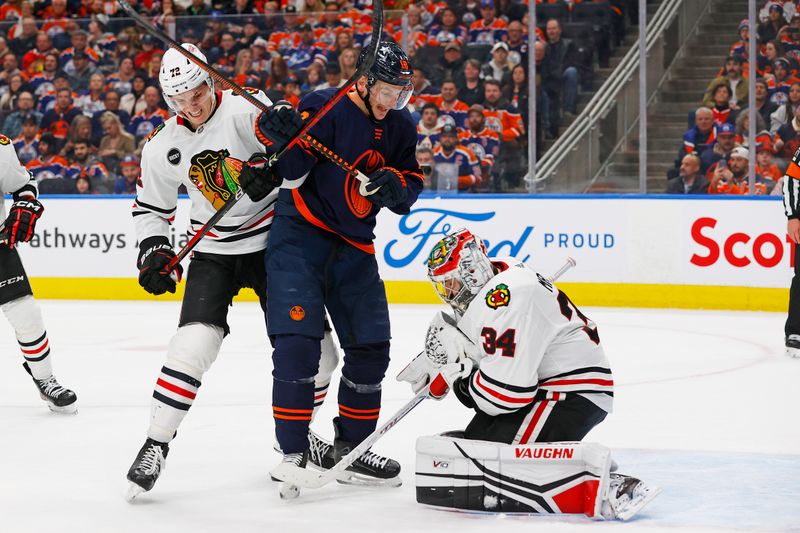 Jan 25, 2024; Edmonton, Alberta, CAN; Chicago Blackhawks goaltender Petr Mrazek (34) makes a save with Edmonton Oilers forward Zach Hyman (18) looking for a rebound during the third period at Rogers Place. Mandatory Credit: Perry Nelson-USA TODAY Sports