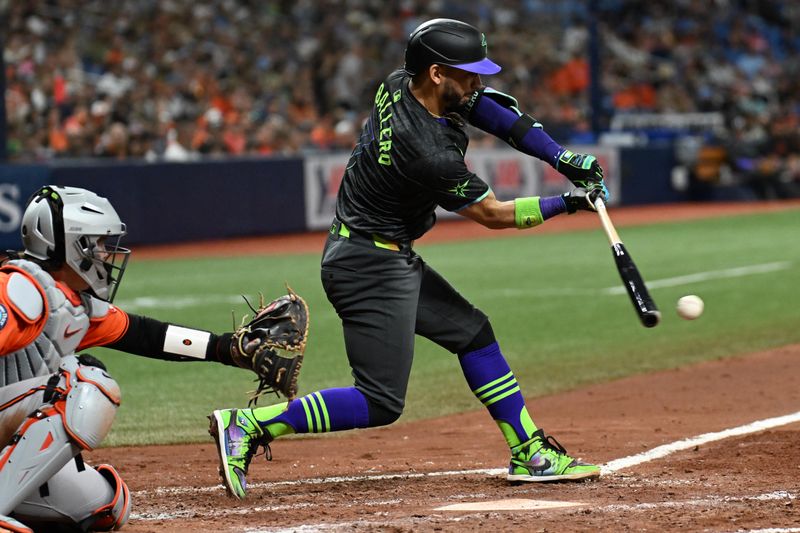 Aug 10, 2024; St. Petersburg, Florida, USA; Tampa Bay Rays short stop Jose Caballero (7) hits an in field single in the fifth inning against the Baltimore Orioles at Tropicana Field. Mandatory Credit: Jonathan Dyer-USA TODAY Sports