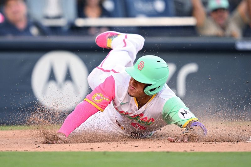 Jul 7, 2023; San Diego, California, USA; San Diego Padres third baseman Manny Machado (13) slides home to score a run against the New York Mets during the first inning at Petco Park. Mandatory Credit: Orlando Ramirez-USA TODAY Sports 