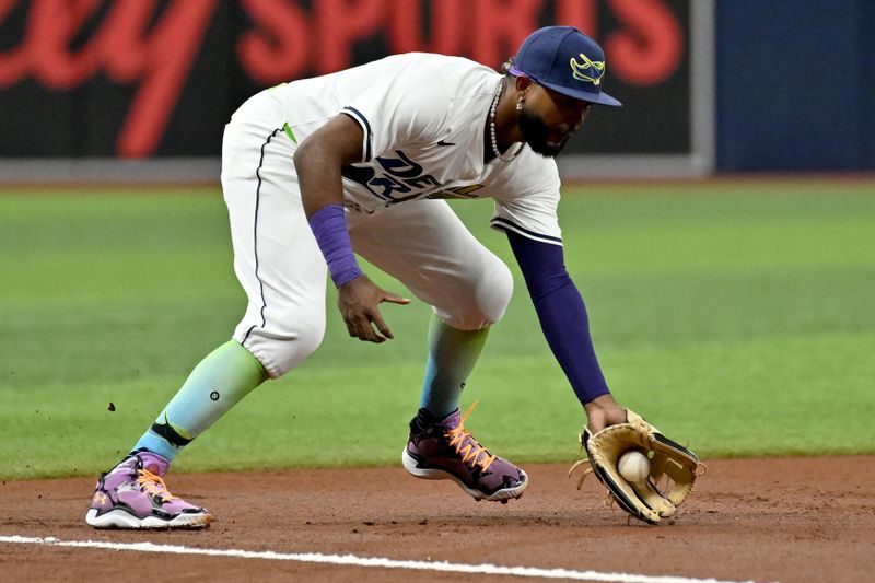 Sep 20, 2024; St. Petersburg, Florida, USA; Tampa Bay Rays third baseman Junior Caminero (13) fields a ground ball in the second inning against the Toronto Blue Jays at Tropicana Field. Mandatory Credit: Jonathan Dyer-Imagn Images