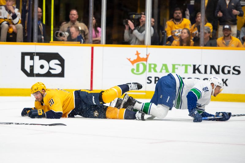 Apr 28, 2024; Nashville, Tennessee, USA; Nashville Predators center Colton Sissons (10) and Vancouver Canucks center Dakota Joshua (81) collided during the first period in game four of the first round of the 2024 Stanley Cup Playoffs at Bridgestone Arena. Mandatory Credit: Steve Roberts-USA TODAY Sports