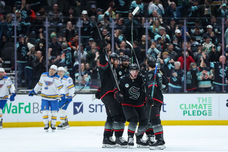 Mar 4, 2026; Seattle, Washington, USA; Seattle Kraken defenseman Vince Dunn (29) celebrates with teammates after scoring a goal in the third period against the St. Louis Blues at Climate Pledge Arena. Mandatory Credit: Kevin Ng-Imagn Images