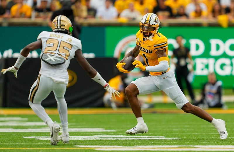 Sep 21, 2024; Columbia, Missouri, USA; Vanderbilt Commodores wide receiver Dariyan Wiley (1) runs with the ball against Vanderbilt Commodores cornerback Martel Hight (25) during the first half at Faurot Field at Memorial Stadium. Mandatory Credit: Jay Biggerstaff-Imagn Images