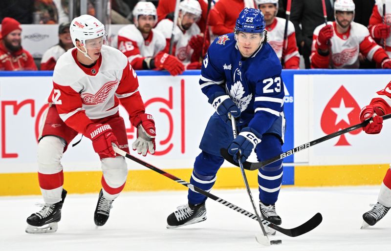 Jan 14, 2024; Toronto, Ontario, CAN;  Toronto Maple Leafs forward Matthews Knies (23) stickhandles the puck away from Detroit Red Wings defenseman Olli Maatta (2) in the first period at Scotiabank Arena. Mandatory Credit: Dan Hamilton-USA TODAY Sports