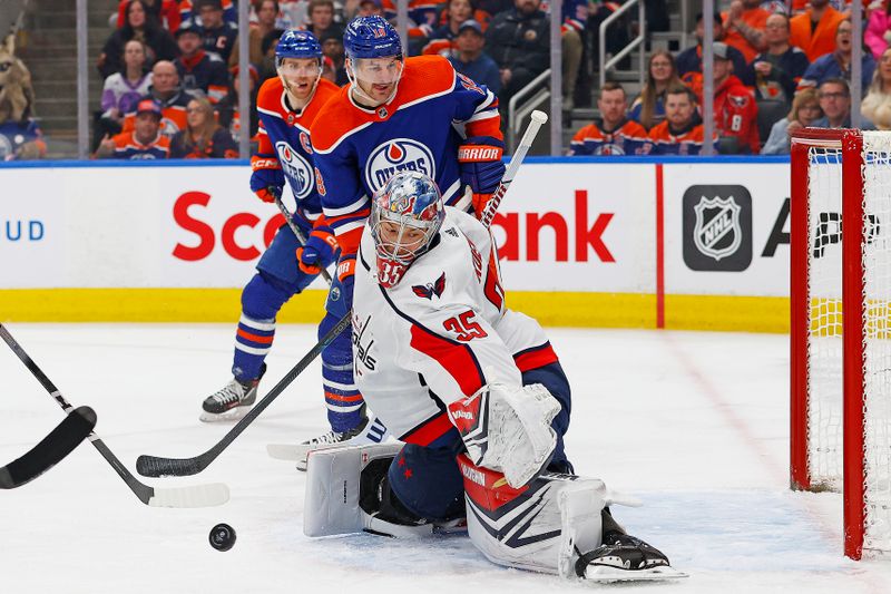 Mar 13, 2024; Edmonton, Alberta, CAN; Washington Capitals goaltender Darcy Kuemper (35) mas on a deflection by Edmonton Oilers forward Zach Hyman (18) during the first period at Rogers Place. Mandatory Credit: Perry Nelson-USA TODAY Sports