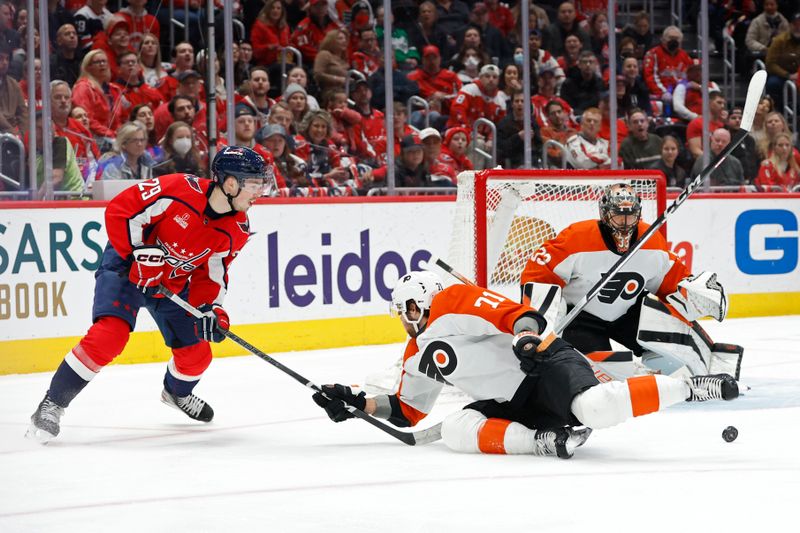 Mar 1, 2024; Washington, District of Columbia, USA; Philadelphia Flyers right wing Tyson Foerster (71) blocks a shot by Washington Capitals center Hendrix Lapierre (29) as Flyers goaltender Samuel Ersson (33) follows the play in the first period at Capital One Arena. Mandatory Credit: Geoff Burke-USA TODAY Sports