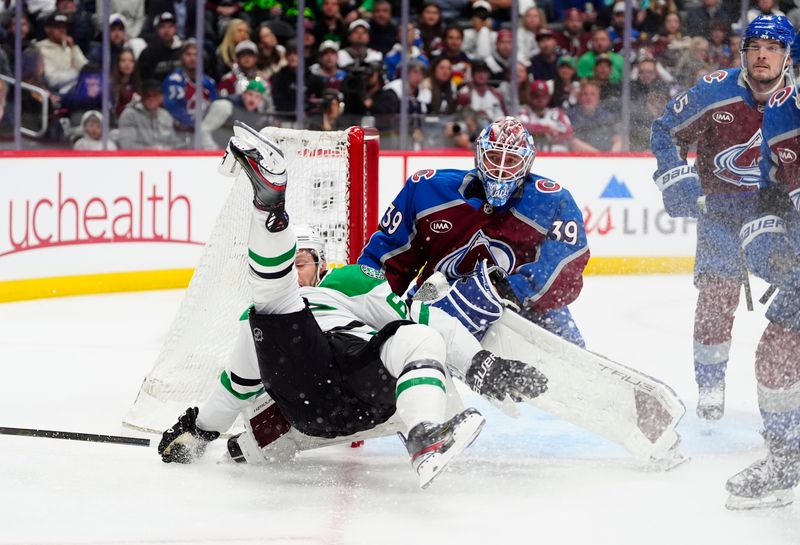May 1, 2025; Denver, Colorado, USA; Dallas Stars defenseman Lian Bichsel (6) falls in front of Colorado Avalanche goaltender Mackenzie Blackwood (39) in the first period in game six of the first round of the 2025 Stanley Cup Playoffs at Ball Arena. Mandatory Credit: Ron Chenoy-Imagn Images
