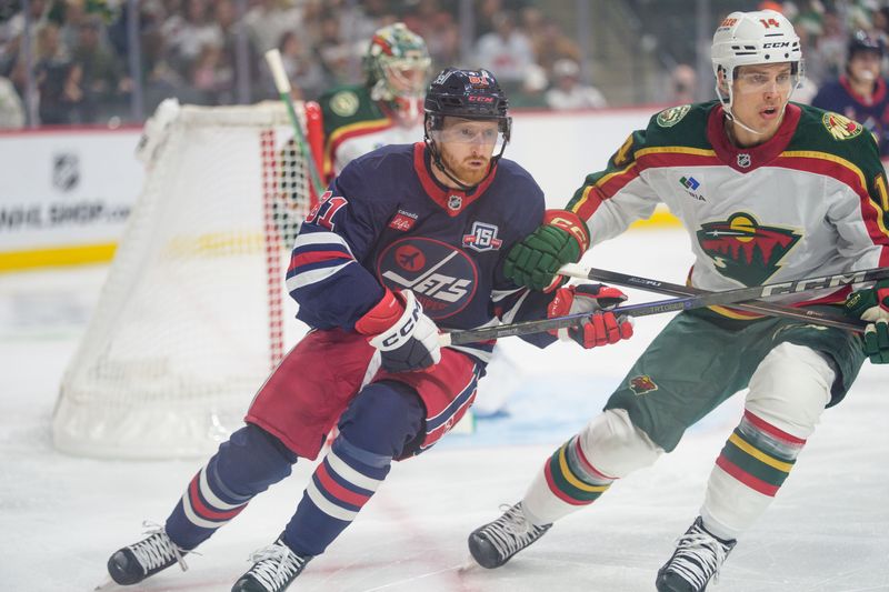 Oct 28, 2025; Saint Paul, Minnesota, USA; Winnipeg Jets left wing Kyle Connor (81) in action against Minnesota Wild center Joel Eriksson Ek (14) in the first period at Grand Casino Arena. Mandatory Credit: Matt Blewett-Imagn Images