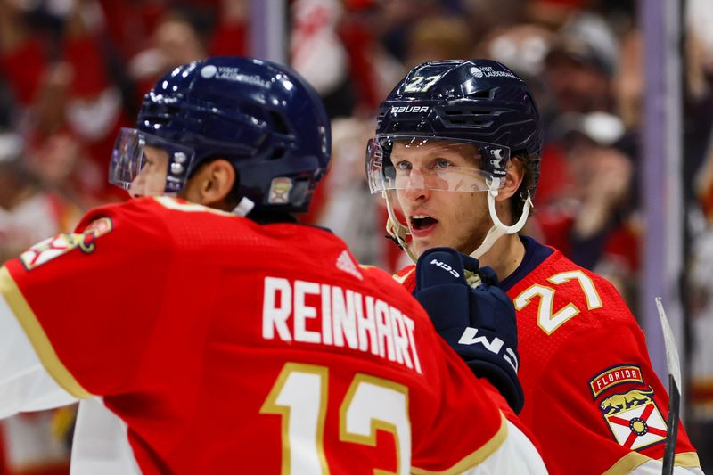 May 8, 2024; Sunrise, Florida, USA; Florida Panthers center Eetu Luostarinen (27) celebrates with center Sam Reinhart (13) after scoring against the Boston Bruins during the third period in game two of the second round of the 2024 Stanley Cup Playoffs at Amerant Bank Arena. Mandatory Credit: Sam Navarro-USA TODAY Sports