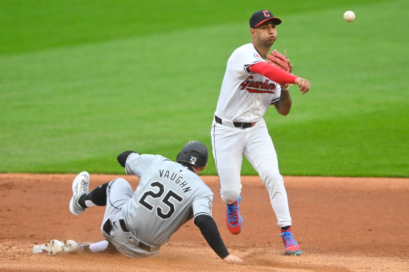 Apr 10, 2024; Cleveland, Ohio, USA; Cleveland Guardians shortstop Brayan Rocchio (4) throws to first base after a fielder’s choice force out of Chicago White Sox designated hitter Andrew Vaughn (25) in the first inning at Progressive Field. Mandatory Credit: David Richard-USA TODAY Sports