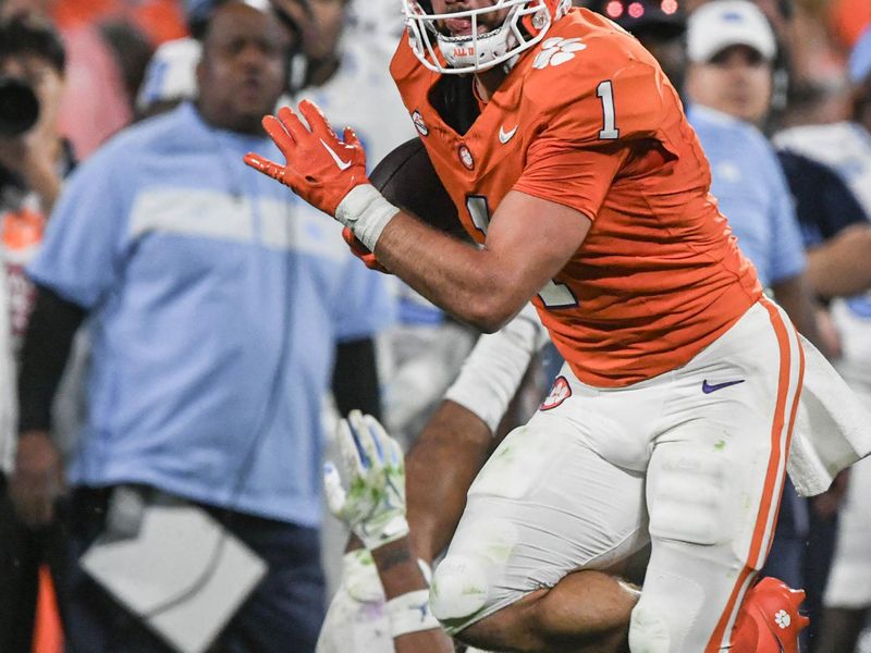 Nov 18, 2023; Clemson, South Carolina, USA; Clemson Tigers running back Will Shipley (1) runs the ball for a 33 yard touchdown against North Carolina Tar Heels linebacker Cedric Gray (33) during the third quarter at Memorial Stadium. Mandatory Credit: Ken Ruinard-USA TODAY Sports