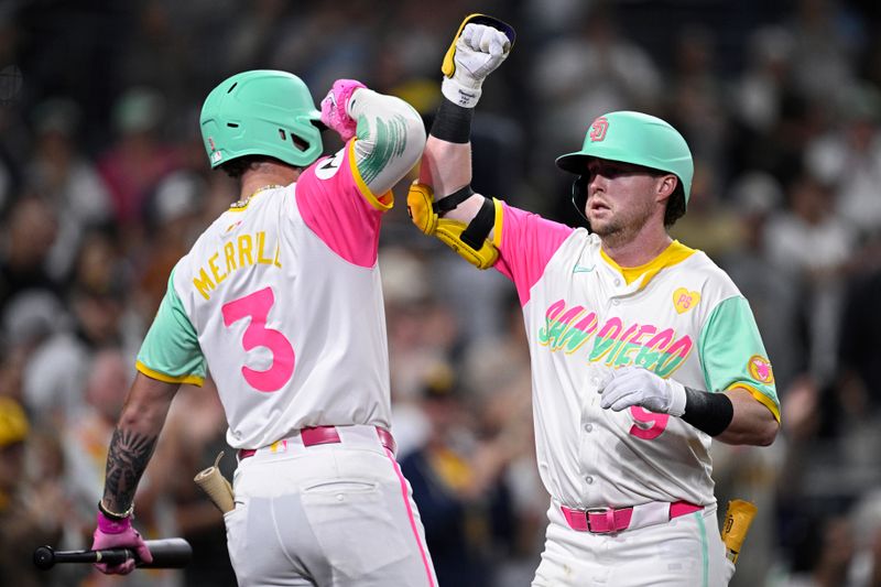 Jun 21, 2024; San Diego, California, USA; San Diego Padres second baseman Jake Cronenworth (9) is congrautlated by center fielder Jackson Merrill (3) after hitting a home run against the Milwaukee Brewers during the sixth inning at Petco Park. Mandatory Credit: Orlando Ramirez-USA TODAY Sports