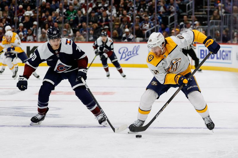 Dec 14, 2024; Denver, Colorado, USA; Nashville Predators center Jonathan Marchessault (81) controls the puck as Colorado Avalanche defenseman Sam Malinski (70) defends in the first period at Ball Arena. Mandatory Credit: Isaiah J. Downing-Imagn Images