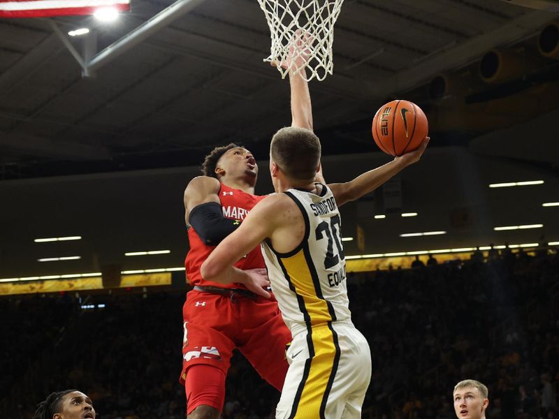 Jan 15, 2023; Iowa City, Iowa, USA; Iowa Hawkeyes guard Connor McCaffery (30) defends the shot from Maryland Terrapins guard Jahari Long (2) at Carver-Hawkeye Arena. Mandatory Credit: Reese Strickland-USA TODAY Sports