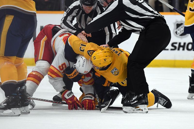 Jan 4, 2024; Nashville, Tennessee, USA; Nashville Predators center Yakov Trenin (13) and Calgary Flames defenseman MacKenzie Weegar (52) have to be separated by linesmen after the whistle during the second period at Bridgestone Arena. Mandatory Credit: Christopher Hanewinckel-USA TODAY Sports