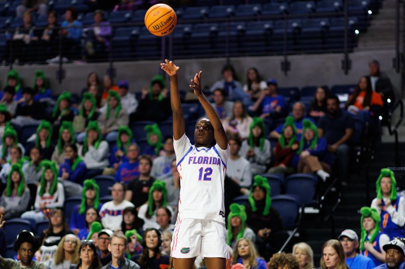 Jan 29, 2026; Gainesville, Florida, USA; Florida Gators guard Daviane Mindoudi (12) attempts a three point basket against the Texas Longhorns during the first half at Exactech Arena at the Stephen C. O'Connell Center. Mandatory Credit: Matt Pendleton-Imagn Images