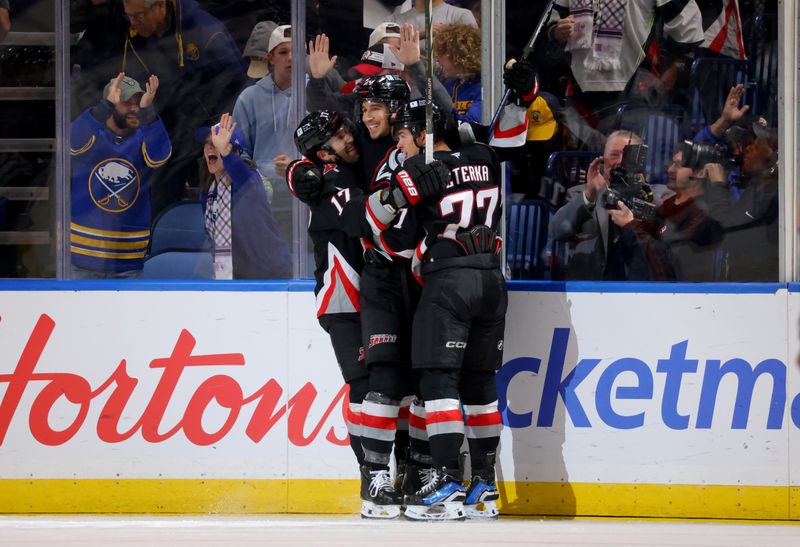 Nov 1, 2024; Buffalo, New York, USA;  Buffalo Sabres center Dylan Cozens (24) celebrates his goal with teammates during the first period against the New York Islanders at KeyBank Center. Mandatory Credit: Timothy T. Ludwig-Imagn Images