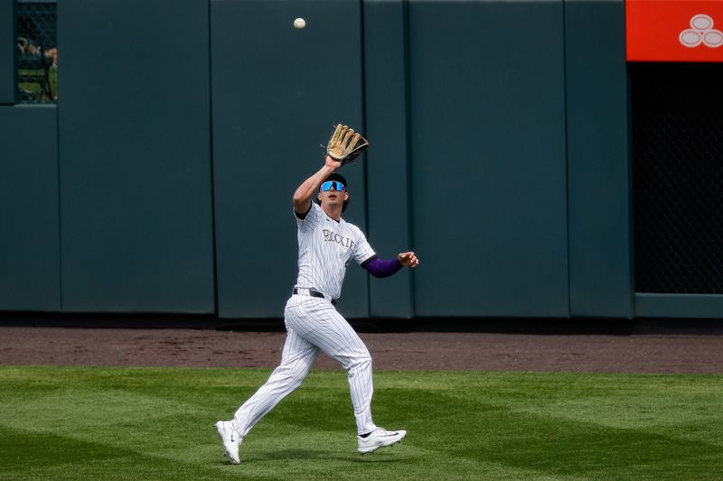 Apr 10, 2024; Denver, Colorado, USA; Colorado Rockies center fielder Brenton Doyle (9) makes a catch for an out in the first inning against the Arizona Diamondbacks at Coors Field. Mandatory Credit: Isaiah J. Downing-USA TODAY Sports