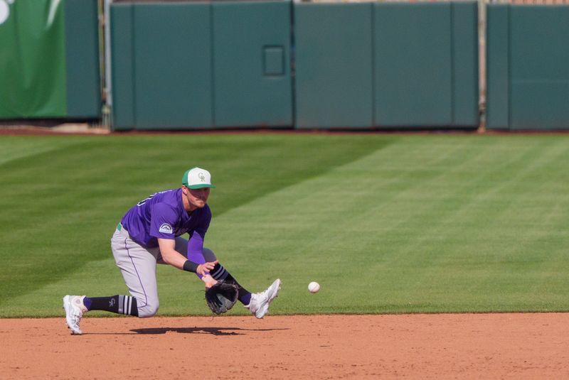 Mar 17, 2024; Scottsdale, Arizona, USA; Colorado Rockies infielder Aaron Schunk (80) fields a ground ball in the sixth inning during a spring training game against the San Francisco Giants at Scottsdale Stadium. Mandatory Credit: Allan Henry-USA TODAY Sports