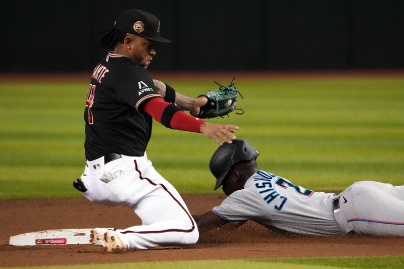 May 9, 2023; Phoenix, Arizona, USA; Miami Marlins center fielder Jazz Chisholm Jr. (2) slides into second base safely for a steal ahead of a throw to Arizona Diamondbacks second baseman Ketel Marte (4) during the fifth inning at Chase Field. Mandatory Credit: Joe Camporeale-USA TODAY Sports