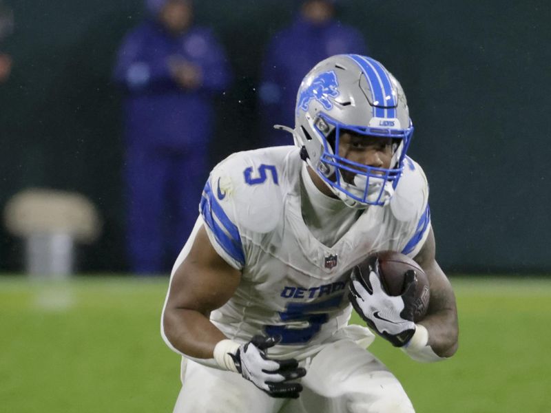 Detroit Lions running back David Montgomery (5) carries during the second half of an NFL football game against the Green Bay Packers, Sunday, Nov. 3, 2024, in Green Bay, Wis. (AP Photo/Mike Roemer)
