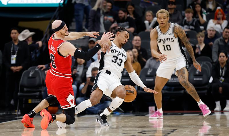 SAN ANTONIO, TX - JANUARY  13:  Tre Jones #33 of the San Antonio Spurs fouls Alex Caruso #6 of the Chicago Bulls in the second half at Frost Bank Center on January 13, 2024 in San Antonio, Texas. NOTE TO USER: User expressly acknowledges and agrees that, by downloading and or using this photograph, User is consenting to terms and conditions of the Getty Images License Agreement. (Photo by Ronald Cortes/Getty Images)