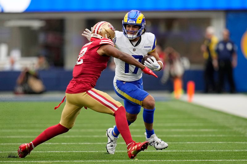 Los Angeles Rams wide receiver Puka Nacua, right, tires to avoid a tackle by San Francisco 49ers cornerback Deommodore Lenoir during the first half of an NFL football game Sunday, Sept. 17, 2023, in Inglewood, Calif. (AP Photo/Gregory Bull)