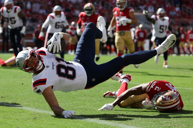 New England Patriots tight end Austin Hooper (81) scores a touchdown over San Francisco 49ers cornerback Deommodore Lenoir (2) during the second half of an NFL football game in Santa Clara, Calif., Sunday, Sept. 29, 2024. (AP Photo/Jed Jacobsohn)