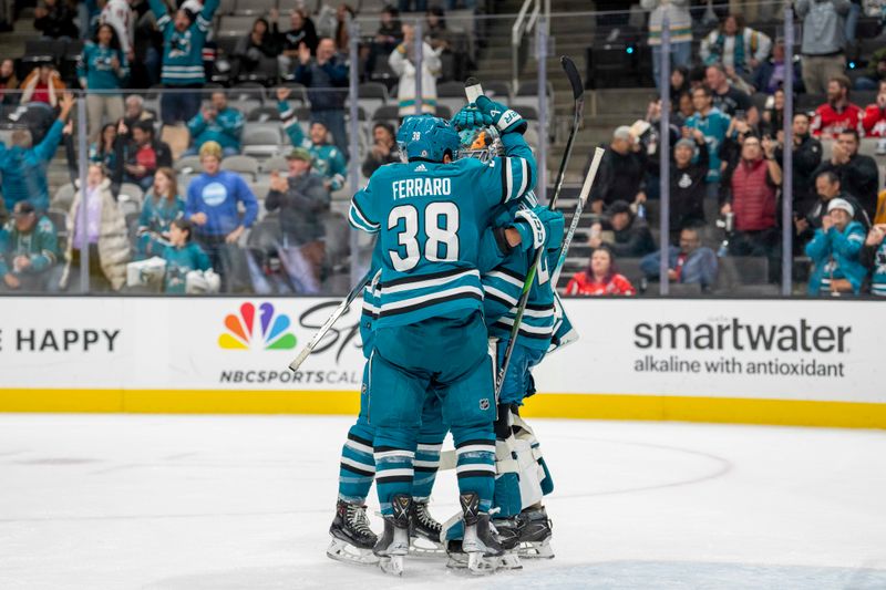 Nov 27, 2023; San Jose, California, USA; San Jose Sharks goaltender Mackenzie Blackwood (29) and San Jose Sharks defenseman Mario Ferraro (38) and teammates celebrate after the game against the Washington Capitals at SAP Center at San Jose. Mandatory Credit: Neville E. Guard-USA TODAY Sports